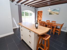 A kitchen with a countertop and dining table at Bullfinch in Lucker