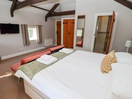 A bedroom with a bed and television at Bullfinch in Lucker