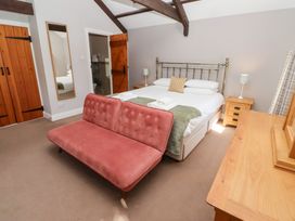 A bedroom with a bed and a sofa at Bullfinch in Lucker