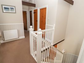 A staircase and doors in a hallway at Bullfinch in Lucker