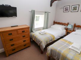 A bedroom with two beds and a dresser at Bullfinch in Lucker
