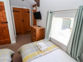 A bedroom with a bed and a dresser at Bullfinch in Lucker