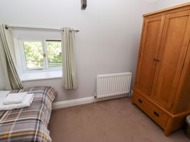 A bedroom with a bed and wardrobe at Bullfinch in Lucker