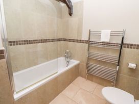 A bathroom featuring a bathtub, towel rail, and toilet at Bullfinch in Lucker