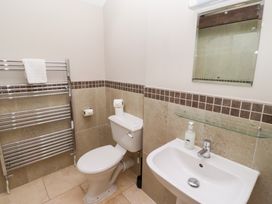 A bathroom with a toilet, sink, and towel rack at Bullfinch in Lucker