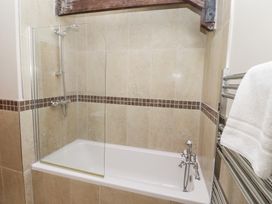 A bathroom with a bathtub and shower at Bullfinch in Lucker