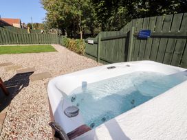 A hot tub in a garden at Bullfinch Lucker