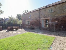 A garden with a table and chairs at Bullfinch in Lucker