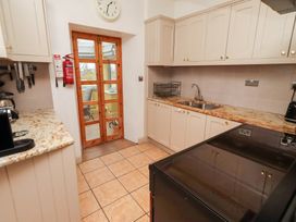 A kitchen with counter and appliances at Adderstone Cottage Bamburgh