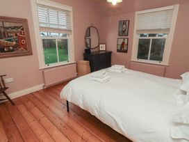 A bedroom with a bed and dresser at Armstrong Cottages No6 in Bamburgh