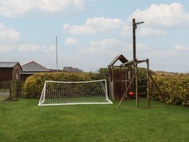 A soccer goal and playground structure in a yard at Armstrong Cottages No6 Bamburgh