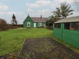A garden with a green house and shed at Armstrong Cottages No6 Bamburgh