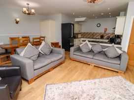 A living room with sofas and a dining table at Pipistrelle in Bamburgh