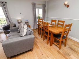 A dining room with a table and sofa at Pipistrelle in Bamburgh