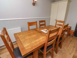 A dining room with a wooden table and chairs at Pipistrelle in Bamburgh