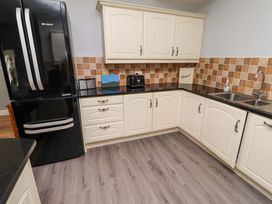 A kitchen featuring cabinets, a refrigerator, and a sink at Pipistrelle in Bamburgh