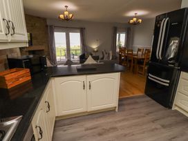 A kitchen with a refrigerator and dining area at Pipistrelle in Bamburgh
