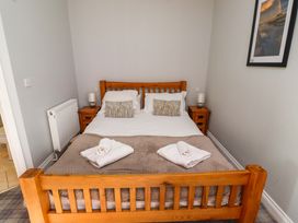 A bedroom with a bed and bedside tables at Pipistrelle in Bamburgh