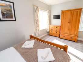A bedroom with a bed and wardrobe at Pipistrelle in Bamburgh