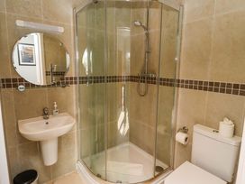 A bathroom with a shower, sink, and toilet at Pipistrelle in Bamburgh