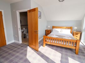 A bedroom with a bed and nightstands at Pipistrelle in Bamburgh