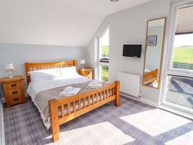 A bedroom with a bed and television at Pipistrelle in Bamburgh