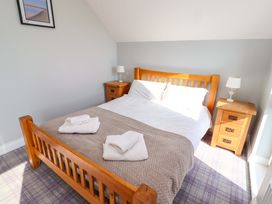 A bedroom with a bed and bedside tables at Pipistrelle in Bamburgh