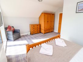 A bedroom with a bed and furniture at Pipistrelle in Bamburgh