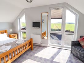 A bedroom with a bed and a television at Pipistrelle in Bamburgh