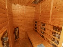 A wooden animal kennel with benches and cages at Pipistrelle in Bamburgh