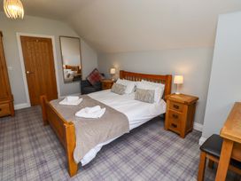 A bedroom with a bed and side tables at Pipistrelle in Bamburgh