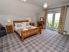 A bedroom with a double bed and furniture at Pipistrelle in Bamburgh