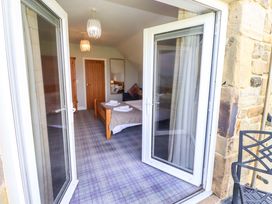 A bedroom with a bed and window at Pipistrelle in Bamburgh