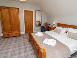 A bedroom with a bed and wardrobe at Pipistrelle in Bamburgh