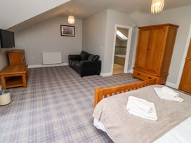 A bedroom with a bed and seating area at Pipistrelle in Bamburgh