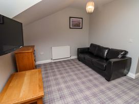 A living room with a sofa and television at Pipistrelle in Bamburgh