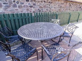 A table and chairs in an outdoor area at Pipistrelle in Bamburgh