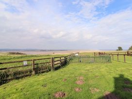 A landscape view with grass and a fence at Pipistrelle in Bamburgh