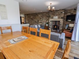 A living room with a sofa and fireplace at Goosander in Bamburgh