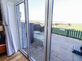 A view from a glass door to an outdoor area at Goosander in Bamburgh