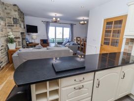 A living room with a sofa and dining table at Goosander in Bamburgh