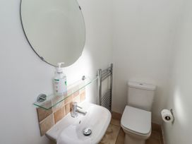 A bathroom with a sink and toilet at Goosander in Bamburgh