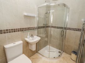 A bathroom featuring a shower, a sink, and a toilet at Goosander in Bamburgh
