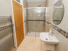 A bathroom with a shower and sink at Goosander in Bamburgh