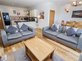 A living room with a sofa and coffee table at Jackdaw in Bamburgh