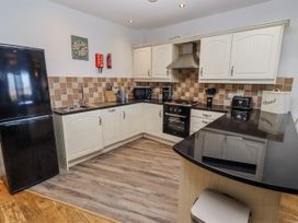 A kitchen with cabinets and appliances at Jackdaw in Bamburgh