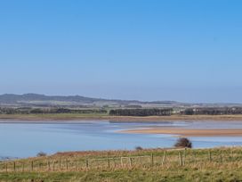 A landscape with a river and fields at Jackdaw in Bamburgh