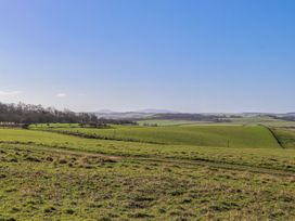 A landscape featuring a green field and hills at Jackdaw in Bamburgh