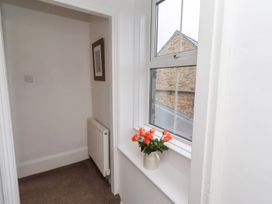 A hallway with a window and a flower pot at Riverside Cottage Warkworth