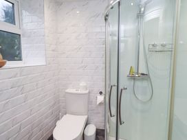 A bathroom with a shower and toilet at Riverside Cottage in Warkworth